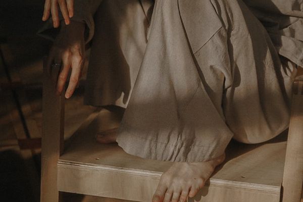 A person meditating peacefully in a sunlit room.